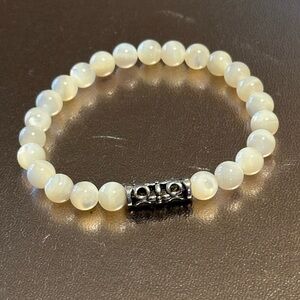 Mother of Pearl stretch bracelet w/silver & gold plated findings. Sold indiv.